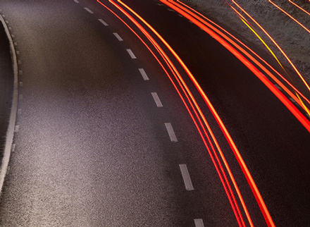 Modern curved street light with a shiny, futuristic glow