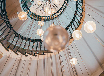 Overhead view of lighting in the centre of a spiral staircase