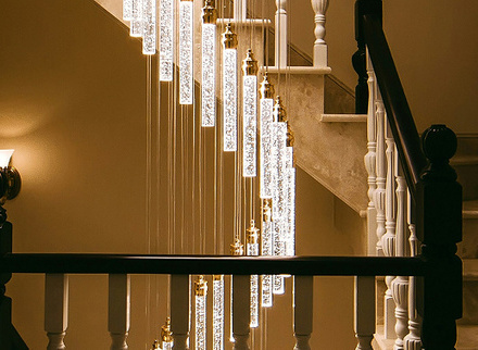 Warm lighting illuminating a spiral staircase from the side