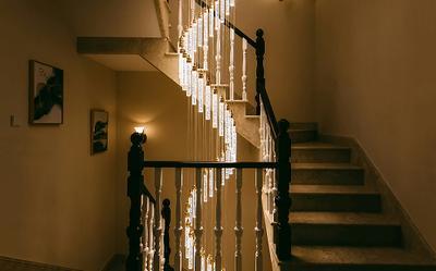 Warm lighting illuminating a spiral staircase from the side